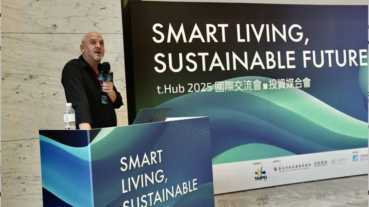 Adrian Watkins on stage opening the Taipei City Government Smart Living, Sustainable Future 2025 event.